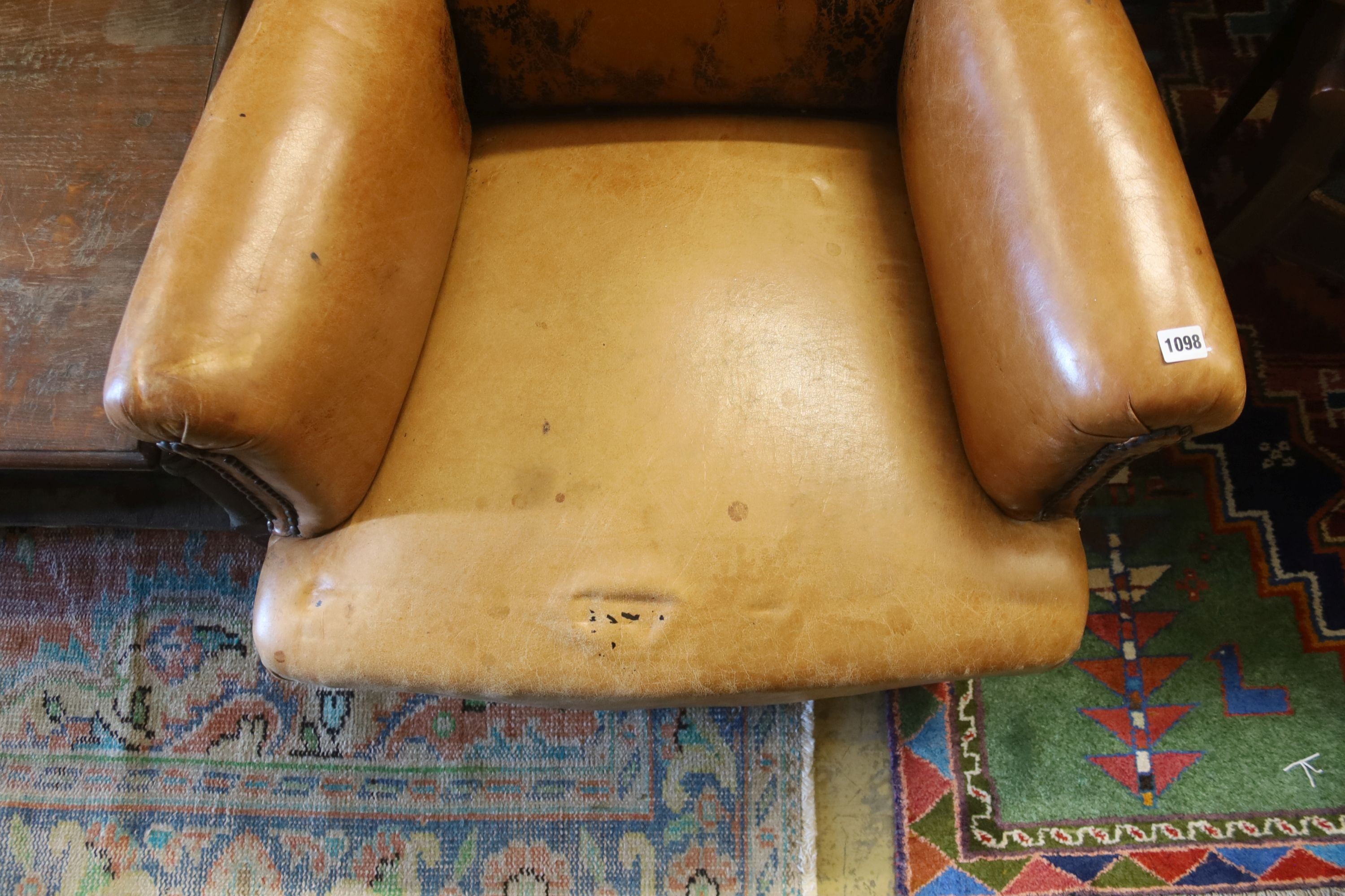 An early 20th century French tan leather club chair, width 78cm, depth 66cm, height 88cm